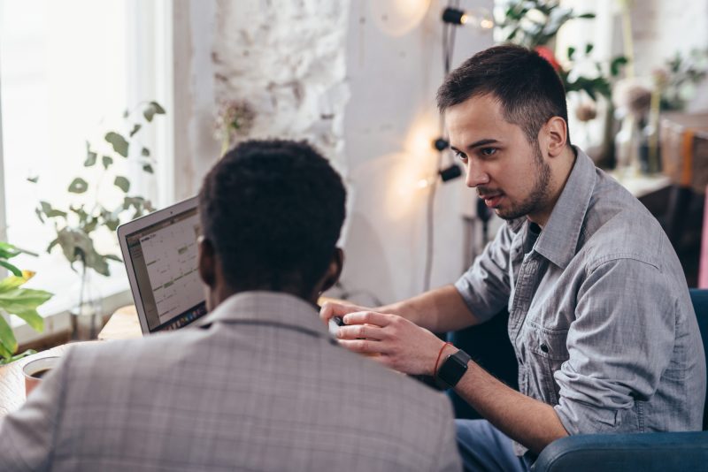 Two business partners working with laptop together